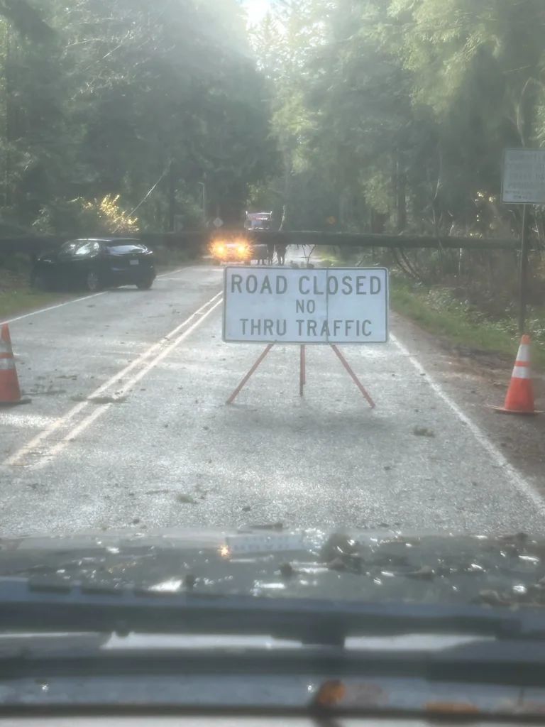 Road closed sign on a wet road after a storm