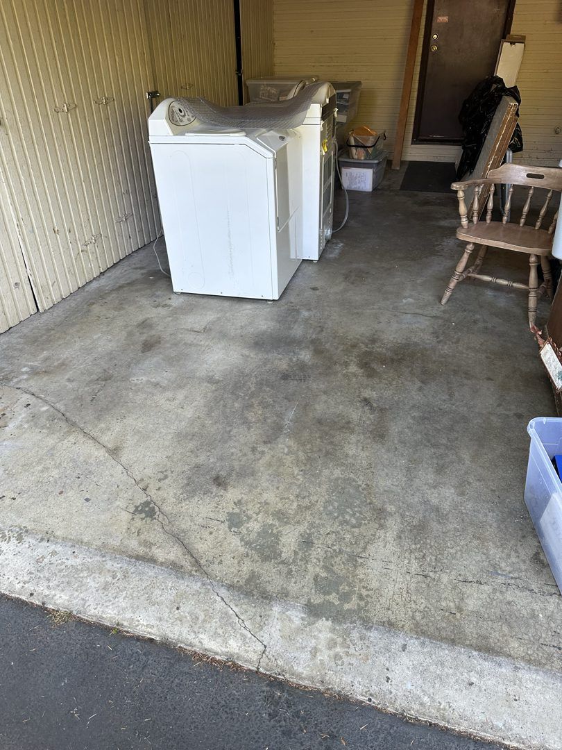Washer, dryer and wooden chair in a Clyde Hill garage before pickup