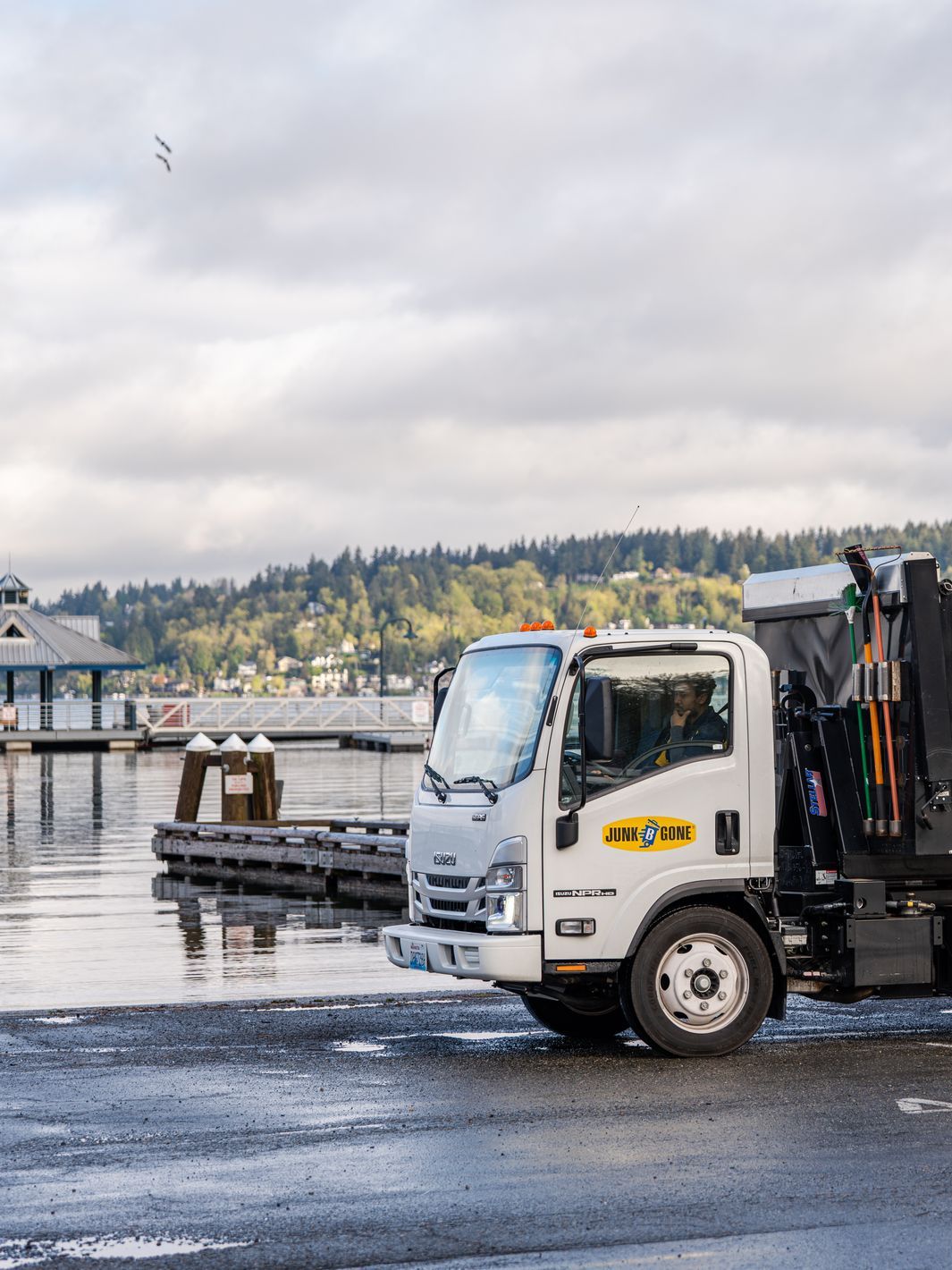 Junk B Gone truck by the marina docks and a pier pavilion on the Kirkland waterfront