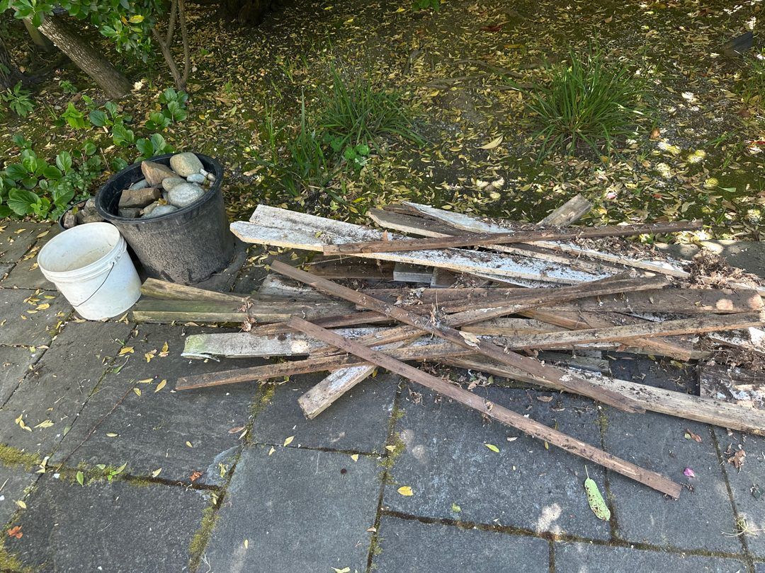 Old boards piled on a Medina patio before pickup