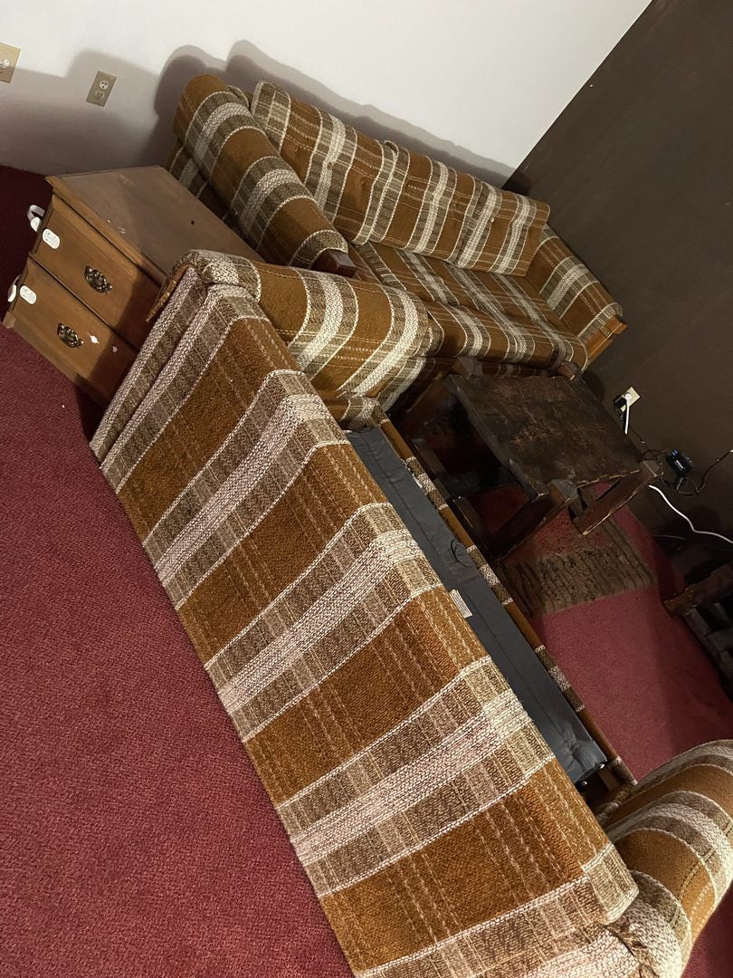Plaid sectional sofa and nightstand ready for removal in a North Bend home
