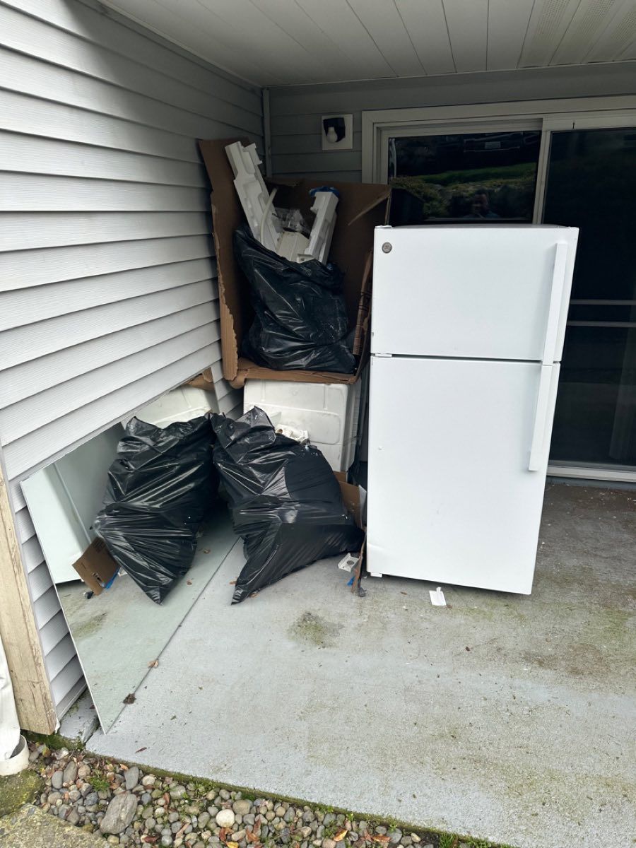 Fridge and trash bags on patio
