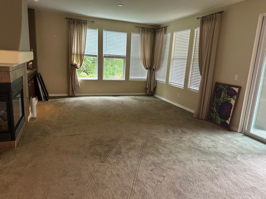 Cleared living room in Seattle - sunlit room with bay windows cleared and bright by Junk B Gone