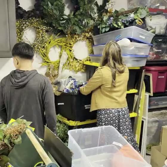 Still from a clip of the crew and the homeowner packing what stays into labeled bins