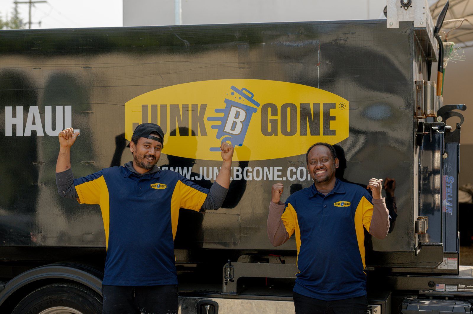 Henok and Amanuel, who lead Junk B Gone's Sort & Haul Days, in front of the company truck