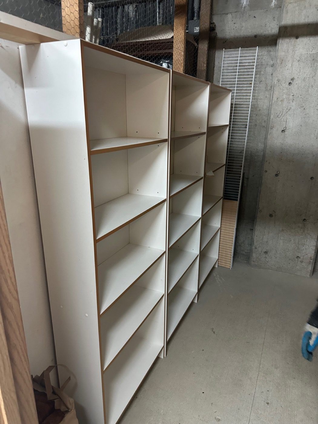 Storage shelving units emptied and left bare after a Junk B Gone clear-out in Seattle