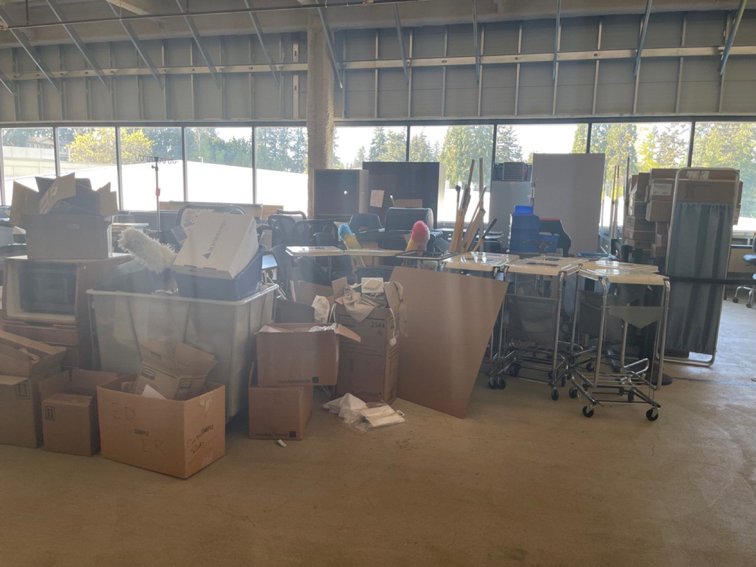 A warehouse storage space packed with boxes and supplies before a Junk B Gone clear-out in Seattle