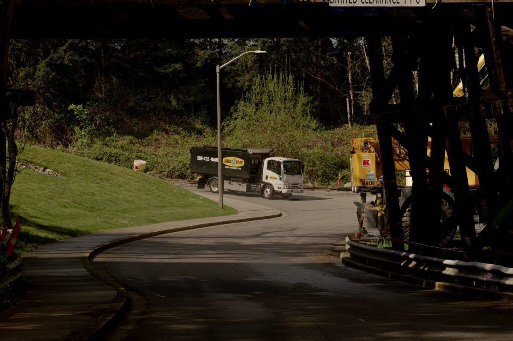 Junk B Gone truck on a wooded Kirkland road — Kirkland junk removal