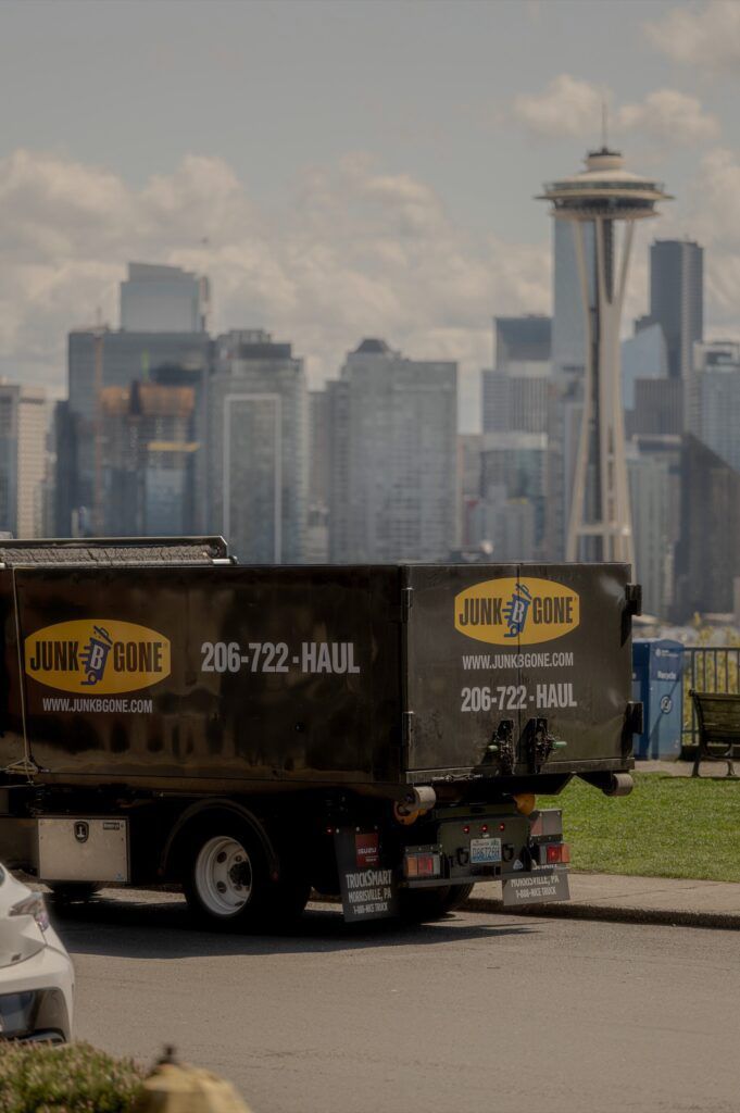 Junk B Gone truck with the Space Needle and the Seattle skyline behind it