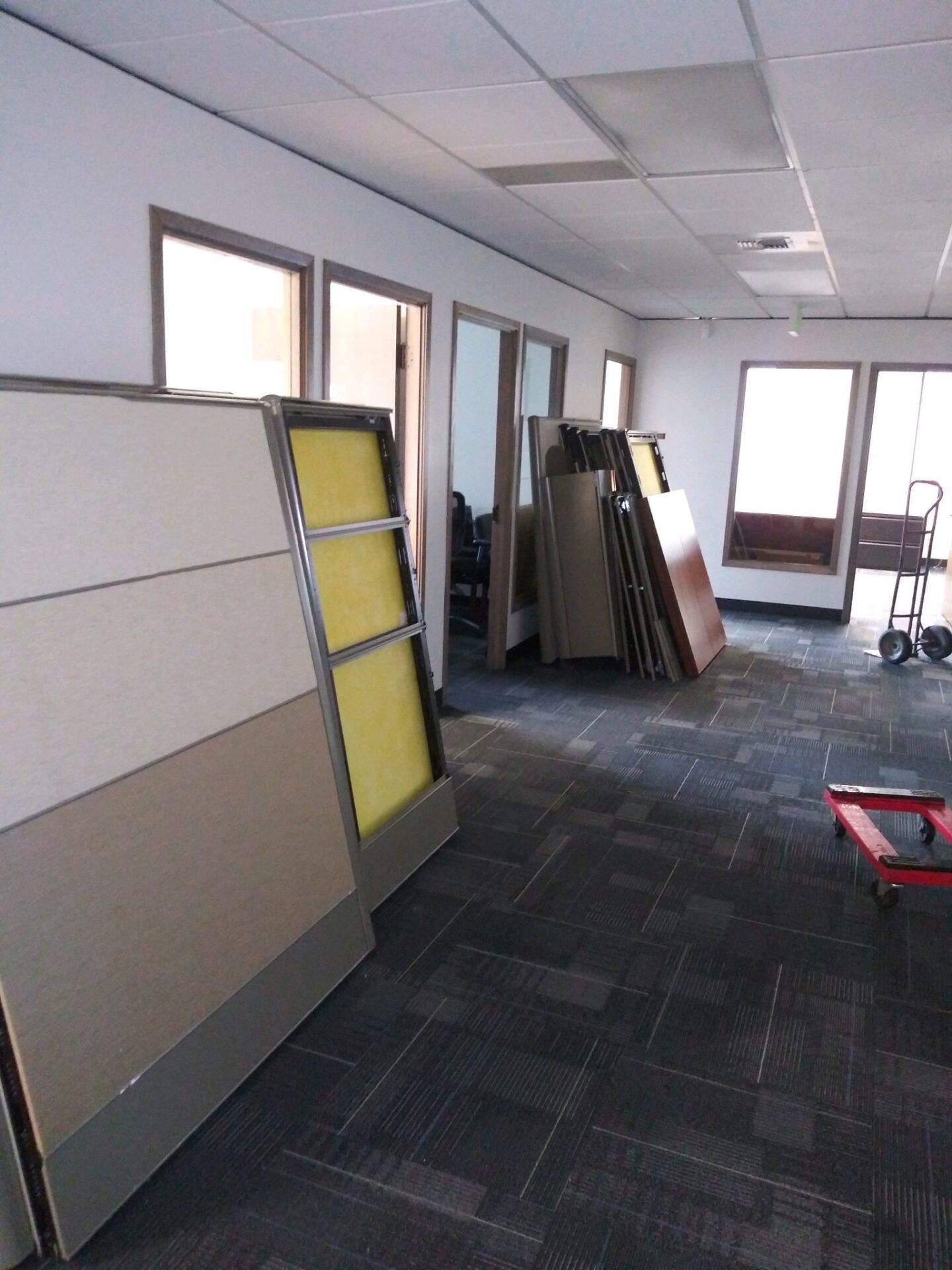 Empty office with stacked cubicle panels waiting to be hauled away