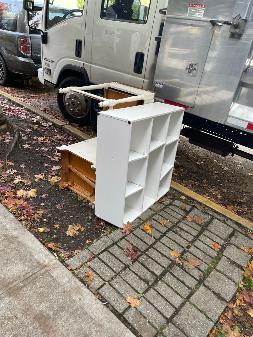 Bookshelf and dresser in a Seattle driveway during a junk removal haul