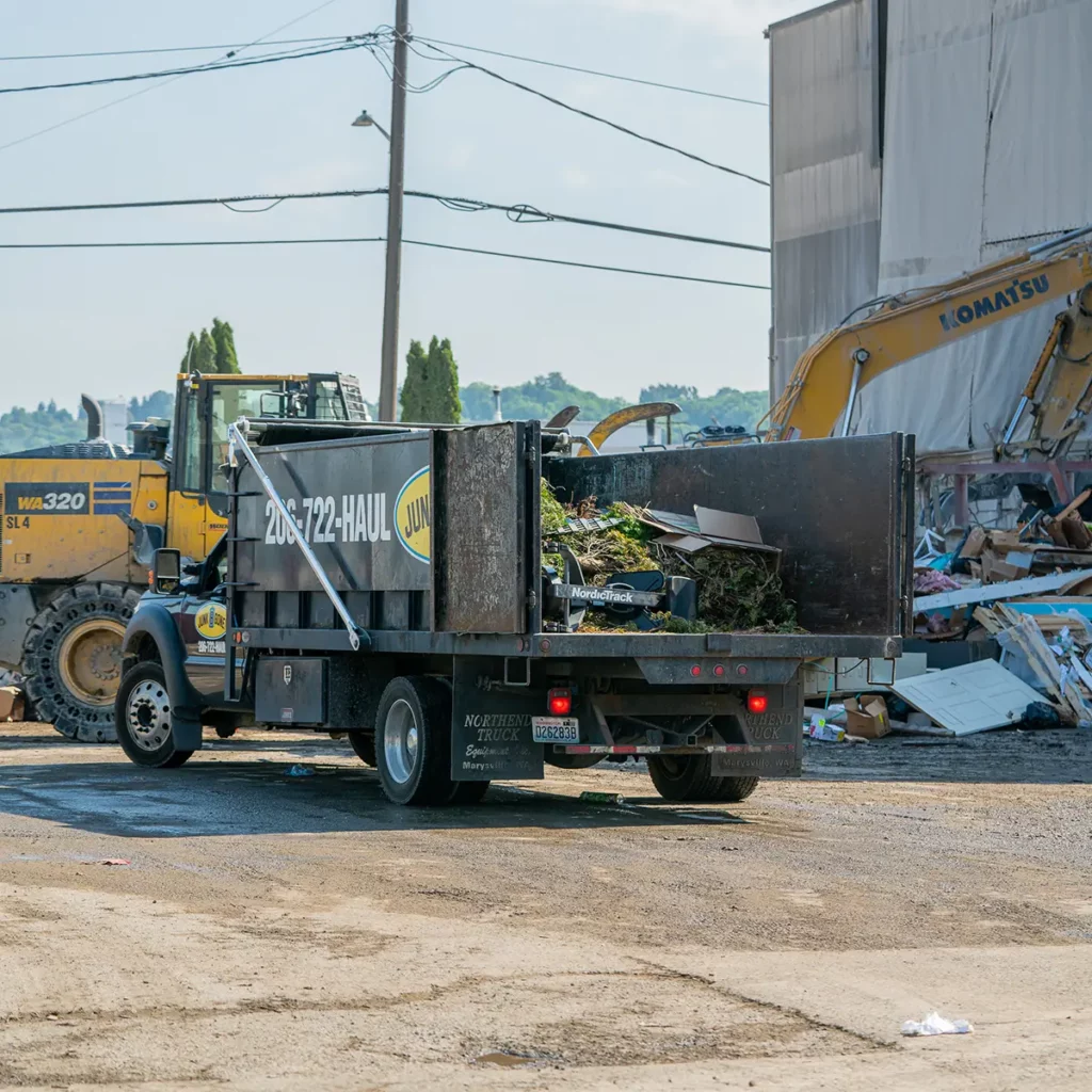 construction debris being removed by junk removal trucks