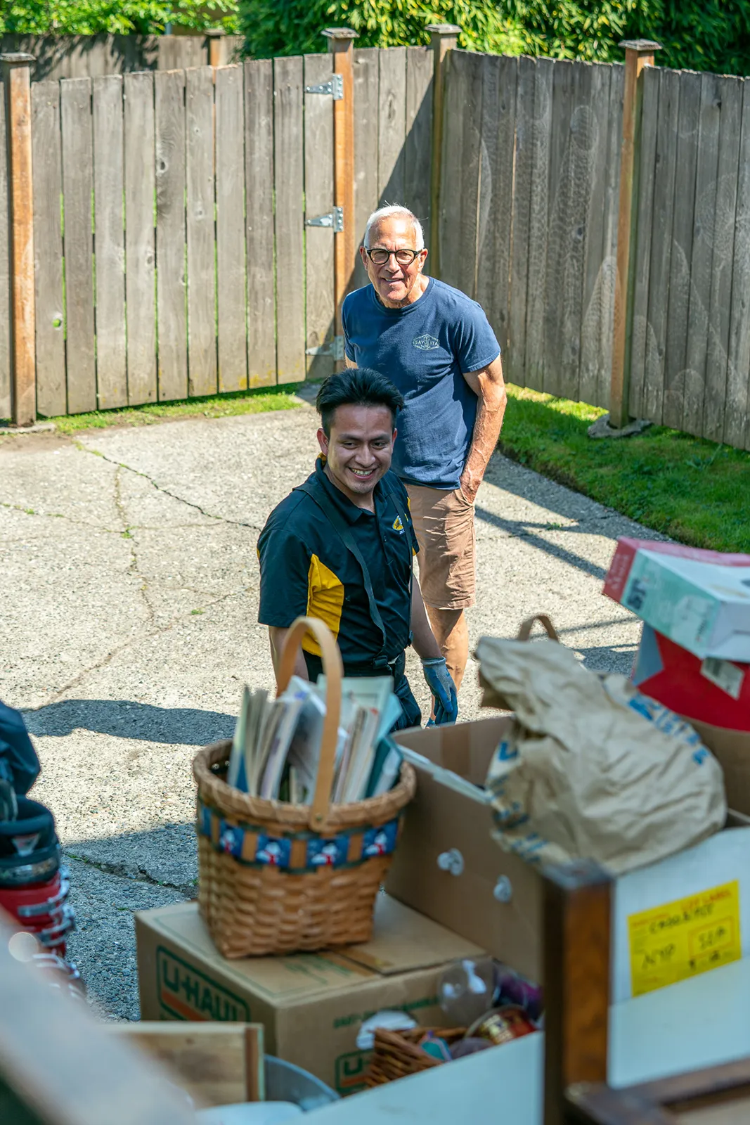 Junk B Gone Employee and Customer Smiling at a Residential Junk Removal Project