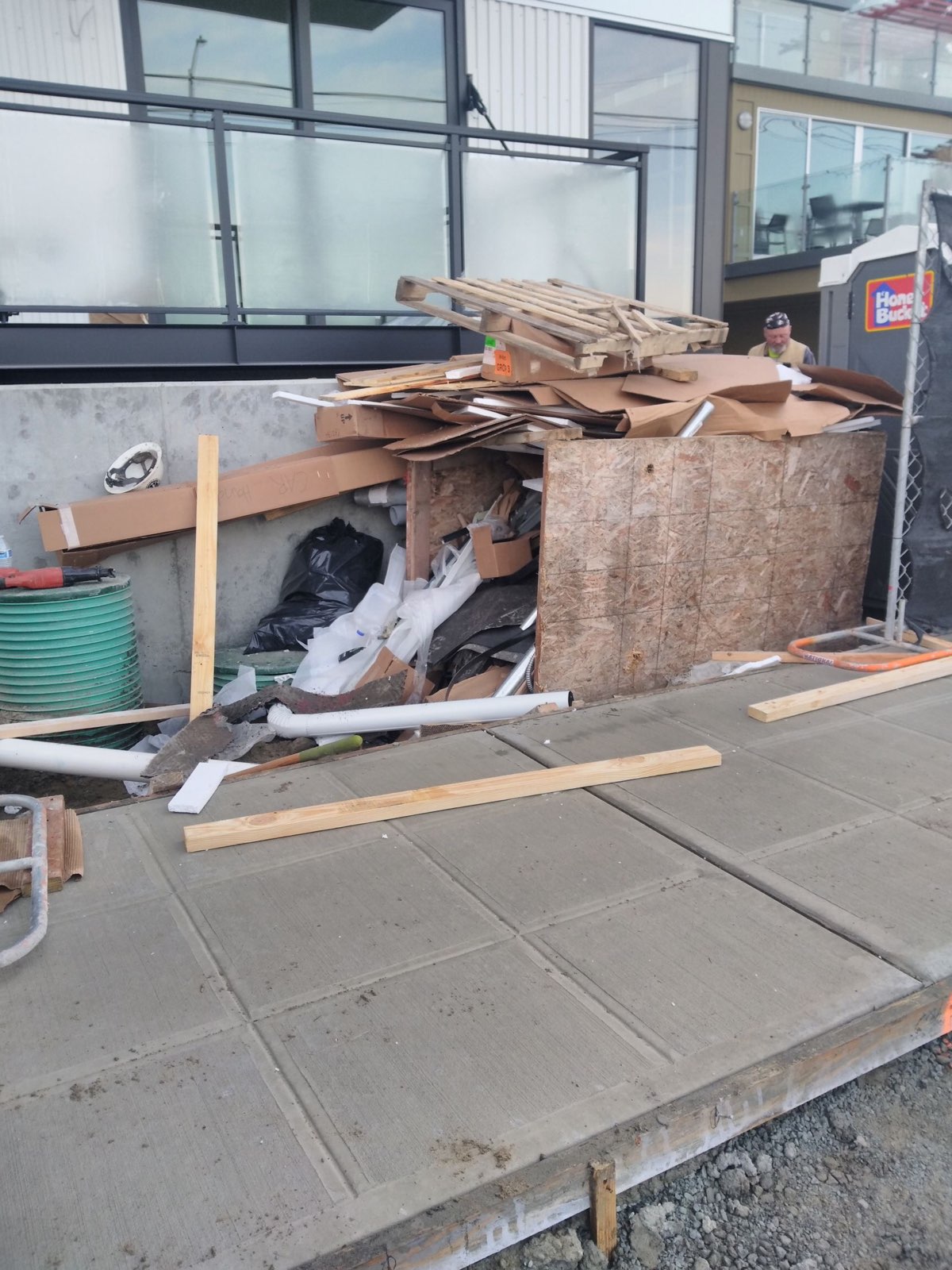 Construction Debris Removal in Seattle, lots of lumber and other misc. materials on a sidewalk