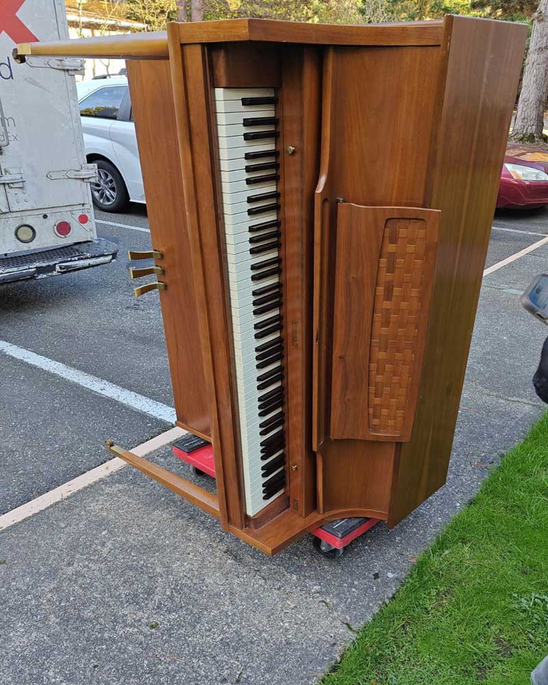 old piano being removed from home