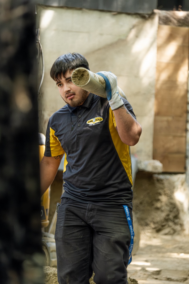 JBG crew carrying pipe